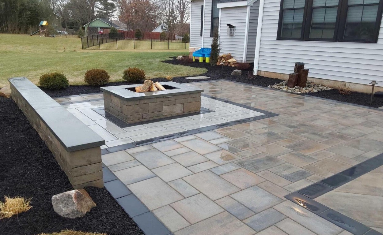 Custom decorative concrete patio with integrated fire pit feature in Bloomington, IL